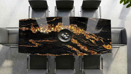 Terra Esstisch in Bootsform mit Magna Black Gold Steinplatte Granit in tiefschwarzer Farbgebung mit exklusiven goldenen Wolkungen und markanter Natursteinstruktur, luxuriöser Blickfang und zeitloses Naturstein-Unikat.